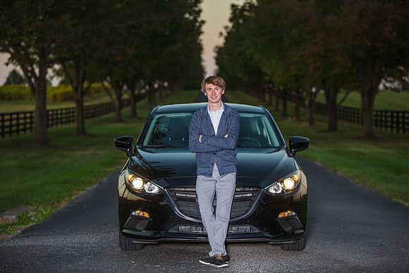 Senior boy with car